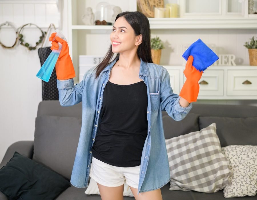 a-woman-with-cleaning-gloves-using-alcohol-spray-sanitiser-to-cleaning-house.jpg